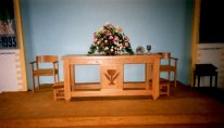 Communion table has a carved relief of chalice and wheat made by George Foreman